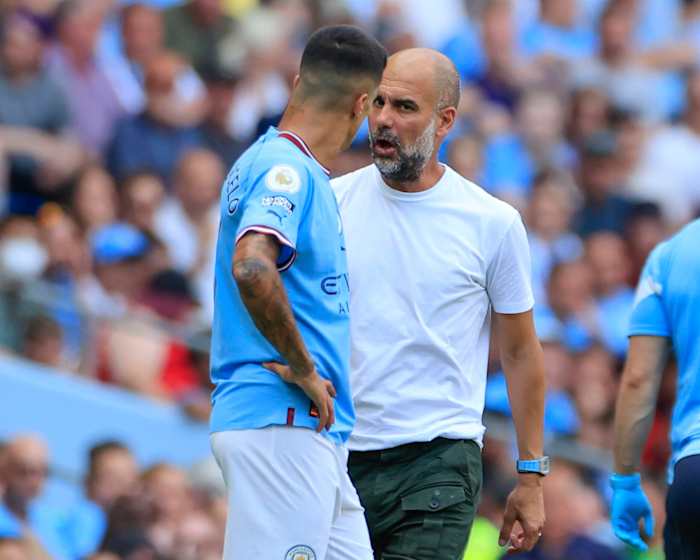 Pep Guardiola (right) pictured speaking to Joao Cancelo during Manchester City's game against Bournemouth in August 2022